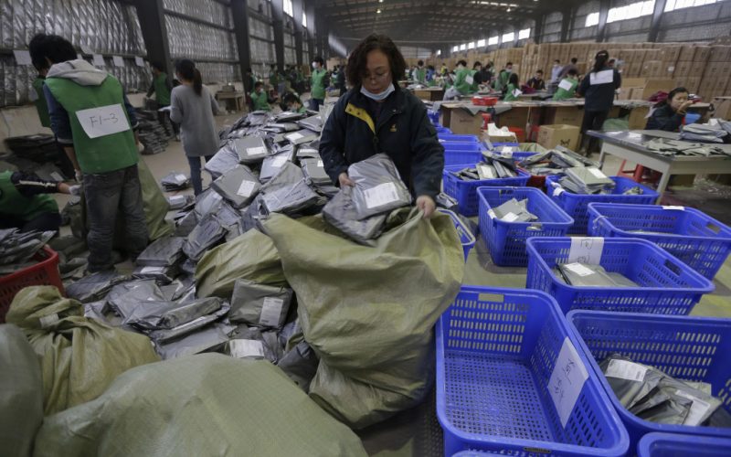 Employees sort packages at a hub of China Post's express delivery service in Wuhan, Hubei province November 11, 2013. Chinese shoppers clicked their way through purchases in an overnight shopping rush on Monday, as China's online retail giants launched massive sales for "Singles' Day" at midnight. By 6 a.m., China's biggest online shopping site, Taobao.com, which operates Tmall.com, had raked in revenues of 10 billion yuan ($1.6 billion) from just 6 hours of sales, Xinhua News Agency reported. REUTERS/Stringer (CHINA - Tags: BUSINESS) CHINA OUT. NO COMMERCIAL OR EDITORIAL SALES IN CHINA - RTX15952